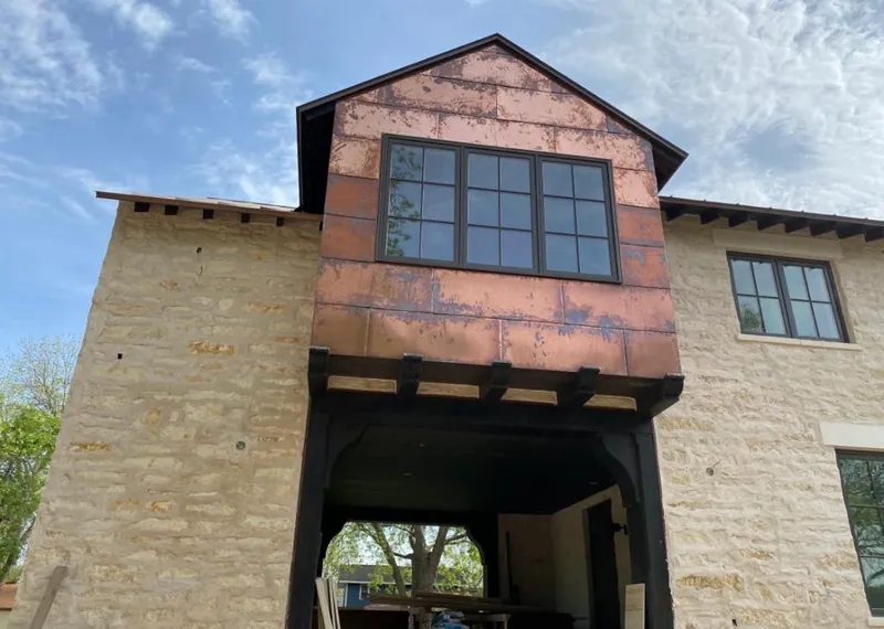 Copper metal panel facade on a stone building for Roof Repair in Whitney