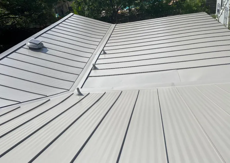 Solar attic fan installed on a metal roof for Roof Ventilation in Whitney